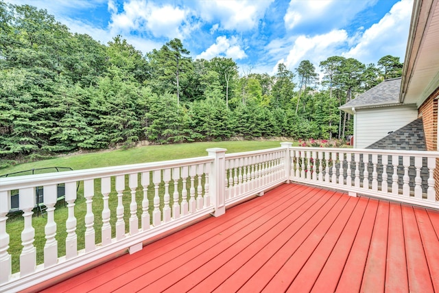 wooden terrace featuring a lawn