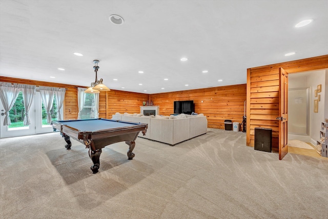 rec room with pool table, wood walls, and light carpet