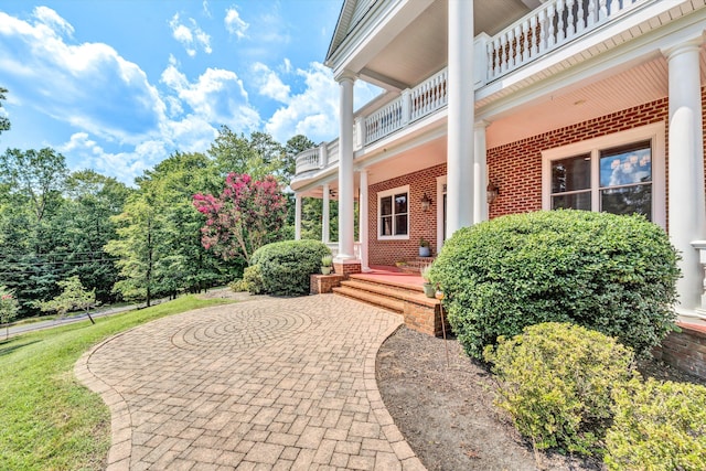 view of exterior entry featuring a balcony