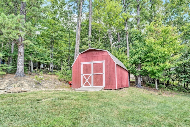 view of outbuilding with a lawn