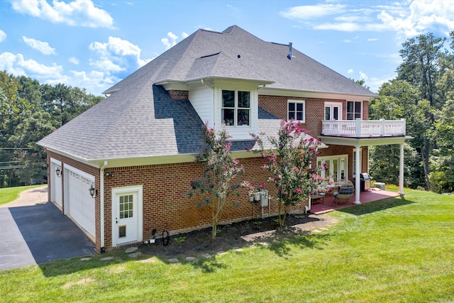 back of house featuring french doors, a yard, and a garage