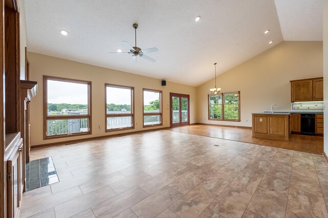 unfurnished living room featuring sink, high vaulted ceiling, ceiling fan with notable chandelier, and light wood-type flooring