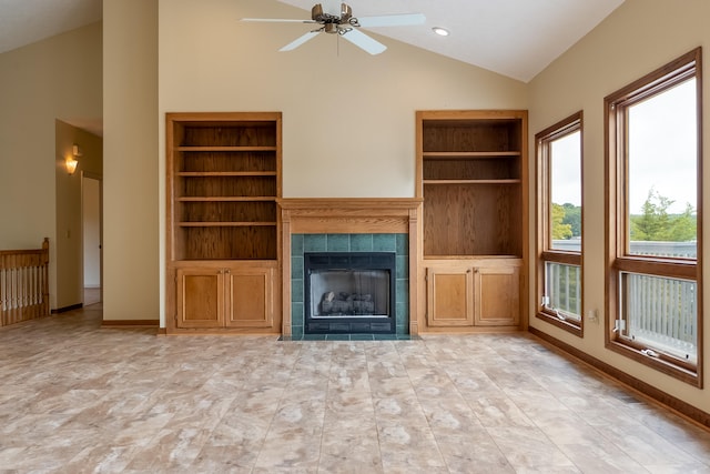 unfurnished living room featuring high vaulted ceiling, ceiling fan, light tile patterned floors, and a tile fireplace