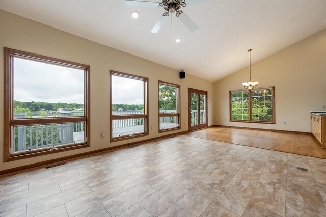 interior space featuring light wood-type flooring, vaulted ceiling, and ceiling fan with notable chandelier