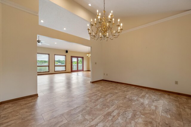 tiled spare room featuring a high ceiling, ceiling fan with notable chandelier, and ornamental molding