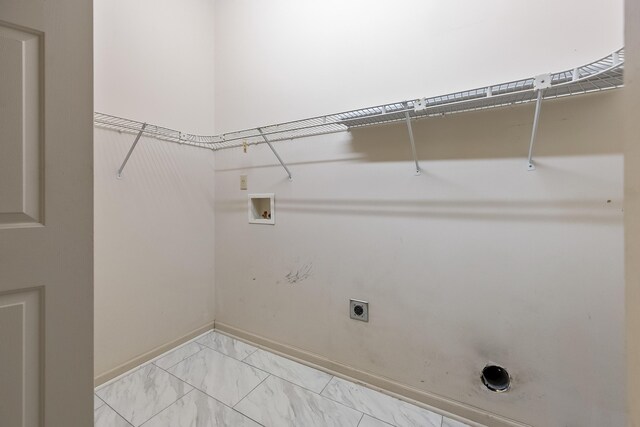 laundry area featuring electric dryer hookup, hookup for a washing machine, and light tile patterned floors