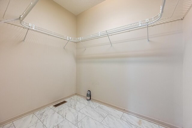 clothes washing area featuring light tile patterned floors