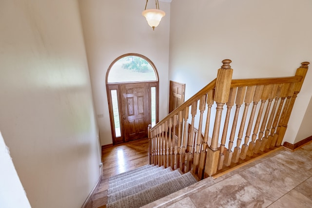 entryway featuring hardwood / wood-style floors and a towering ceiling