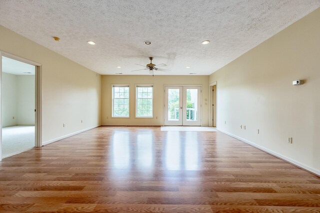 spare room featuring ceiling fan, a textured ceiling, french doors, and hardwood / wood-style floors