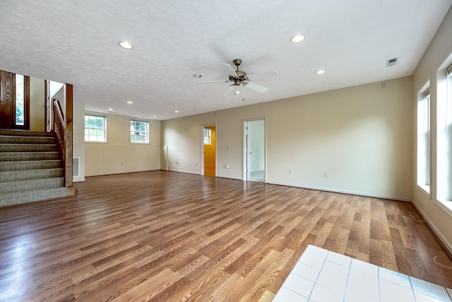 interior space with ceiling fan, light hardwood / wood-style flooring, and a textured ceiling