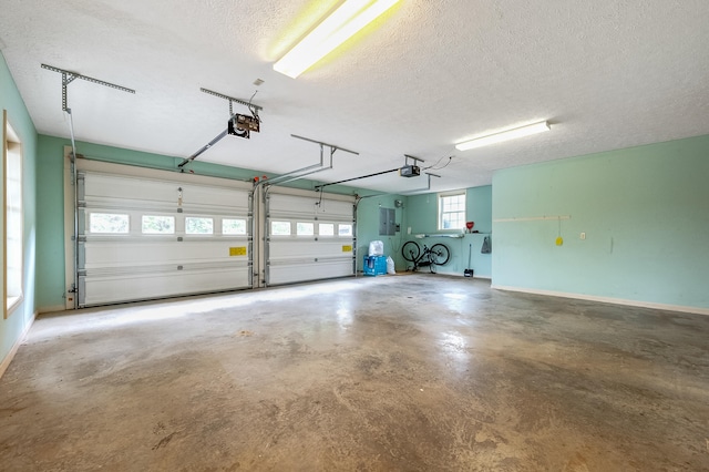 garage with a garage door opener and electric panel