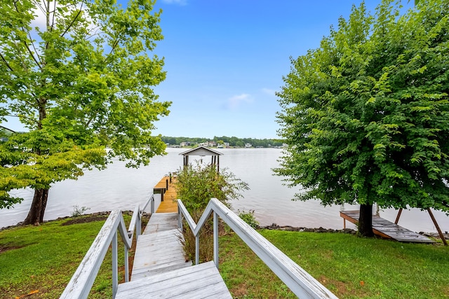 dock area featuring a yard and a water view