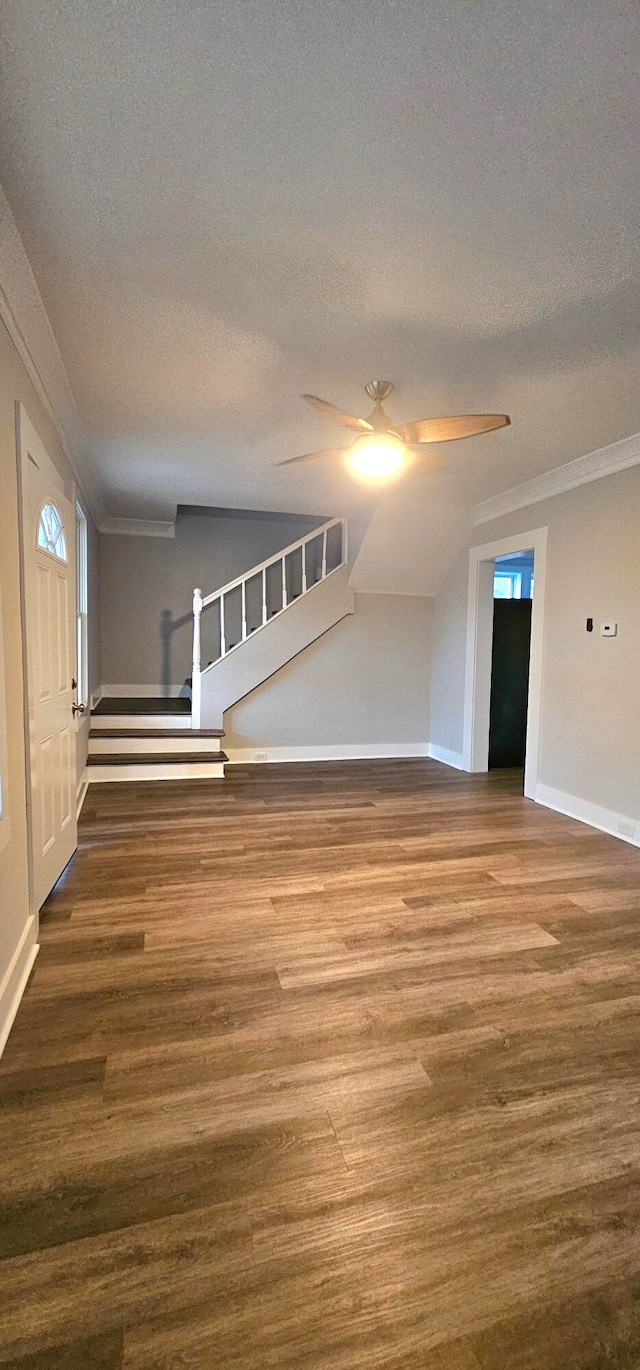 interior space with a textured ceiling, ceiling fan, and hardwood / wood-style flooring