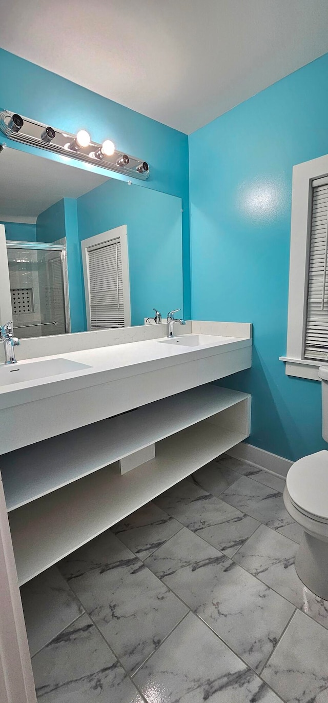 bathroom featuring dual vanity, toilet, and tile patterned floors