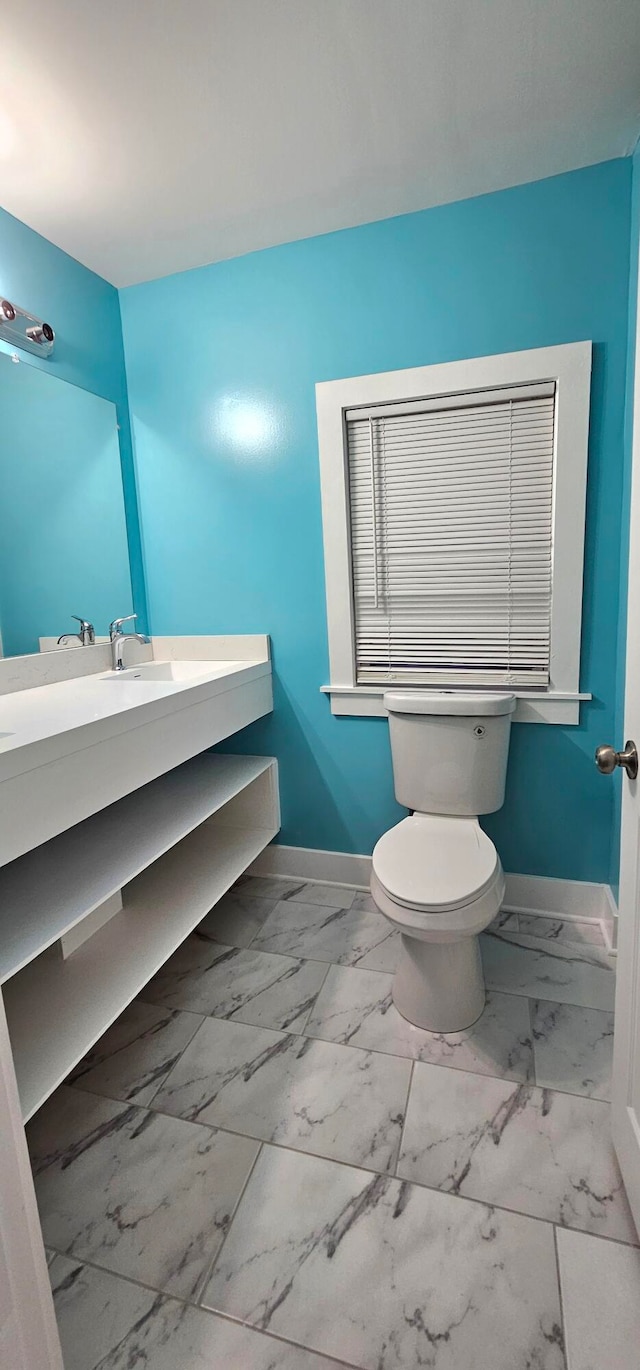 bathroom featuring tile patterned flooring, toilet, and vanity