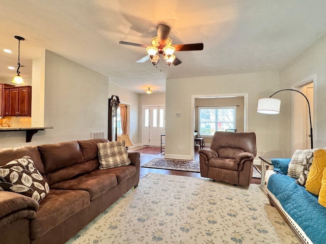 living room featuring ceiling fan and light wood-type flooring