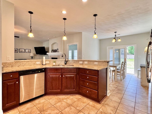 kitchen with light tile patterned flooring, sink, light stone countertops, dishwasher, and pendant lighting