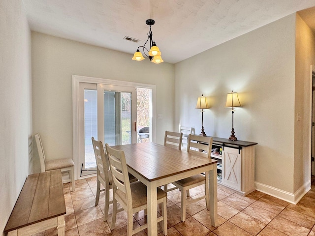 dining space with light tile patterned flooring and an inviting chandelier