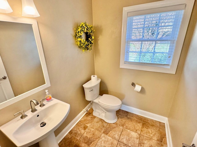 bathroom featuring sink, tile patterned flooring, and toilet