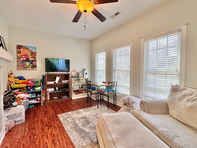 living room featuring ceiling fan and hardwood / wood-style floors