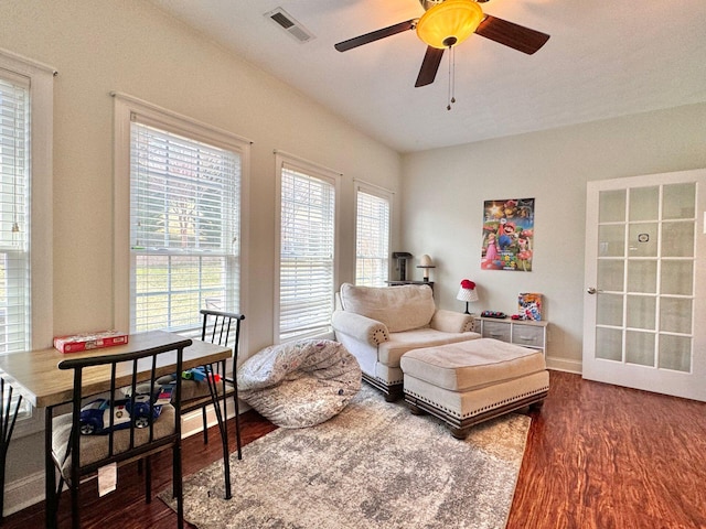 living room with ceiling fan, wood-type flooring, and plenty of natural light