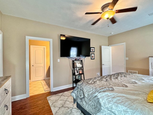 bedroom with light hardwood / wood-style flooring and ceiling fan