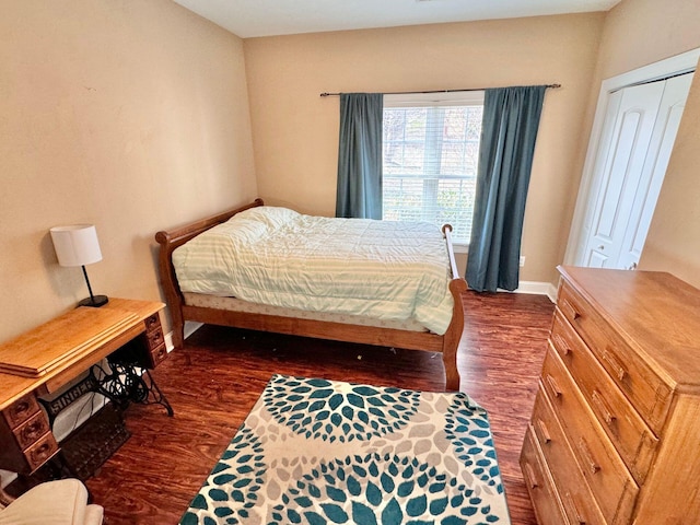 bedroom with dark wood-type flooring and a closet