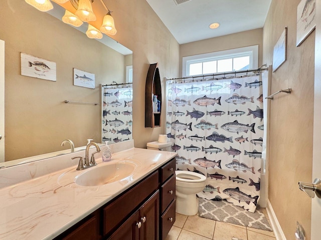 bathroom featuring tile patterned flooring, toilet, and vanity