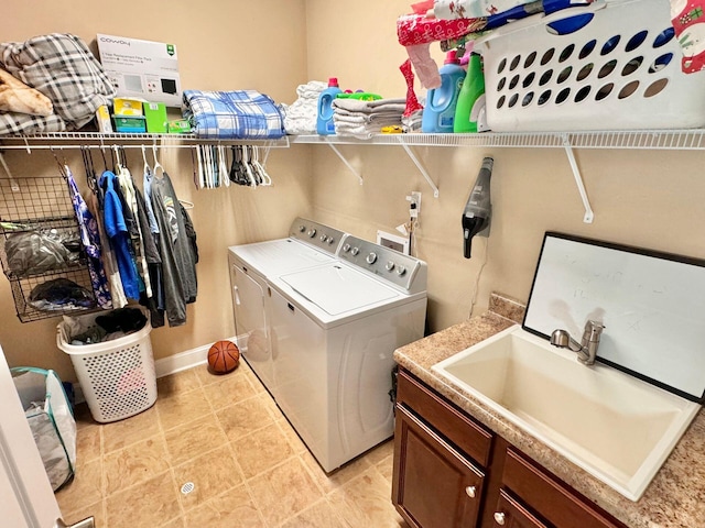 washroom with sink, light tile patterned flooring, and separate washer and dryer