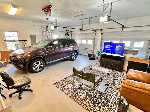 garage with a garage door opener and electric panel