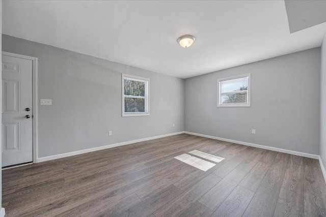 empty room featuring dark wood-type flooring