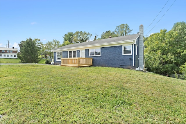 view of front of house featuring a front yard and a deck