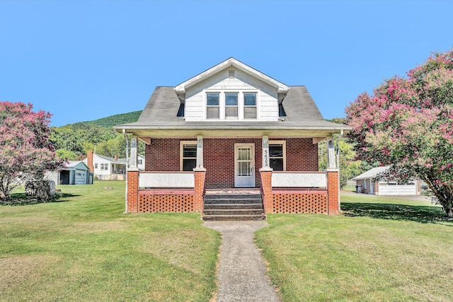 bungalow-style house with a front lawn and a porch