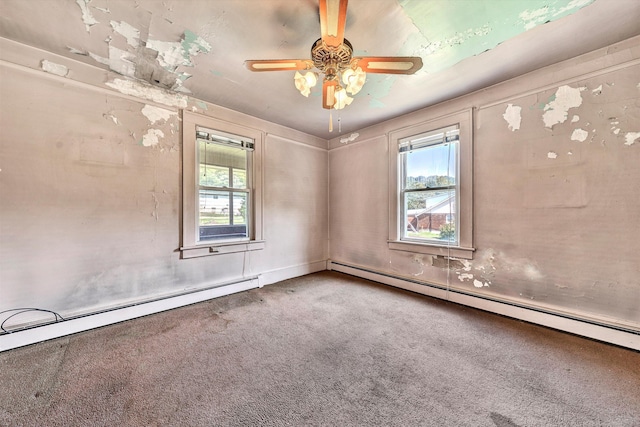 empty room with ceiling fan, plenty of natural light, carpet, and a baseboard heating unit