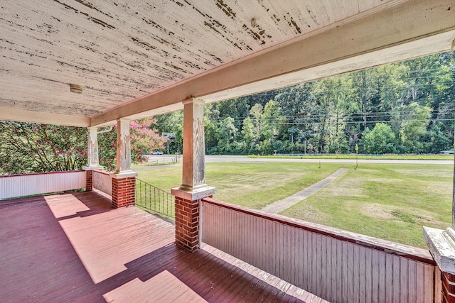 wooden terrace featuring a yard