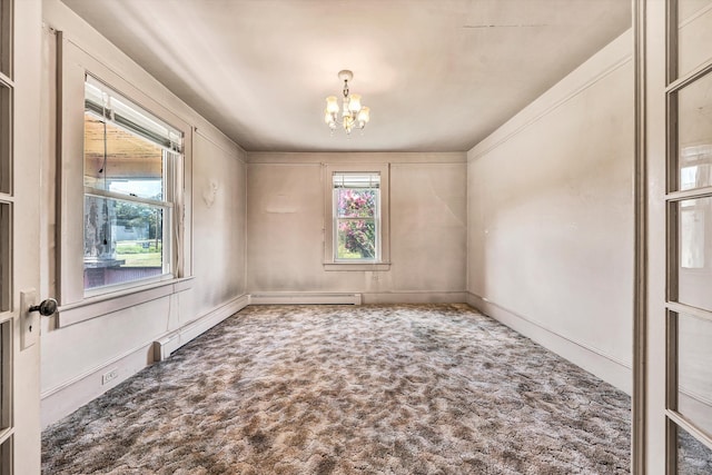 unfurnished room featuring an inviting chandelier, baseboard heating, and carpet flooring