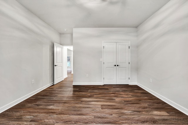 empty room with dark wood-type flooring