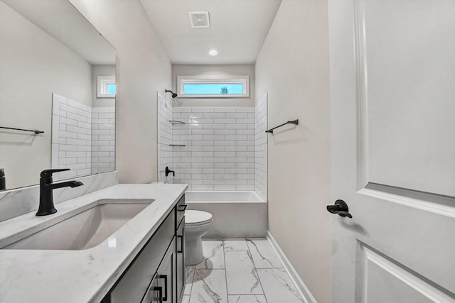 full bathroom with vanity, toilet, and tiled shower / bath