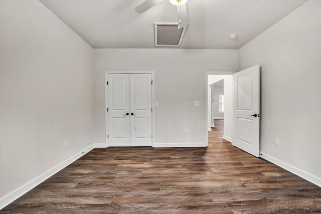 unfurnished bedroom featuring ceiling fan, a closet, and dark wood-type flooring