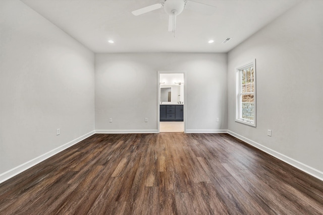 unfurnished room featuring ceiling fan and dark wood-type flooring