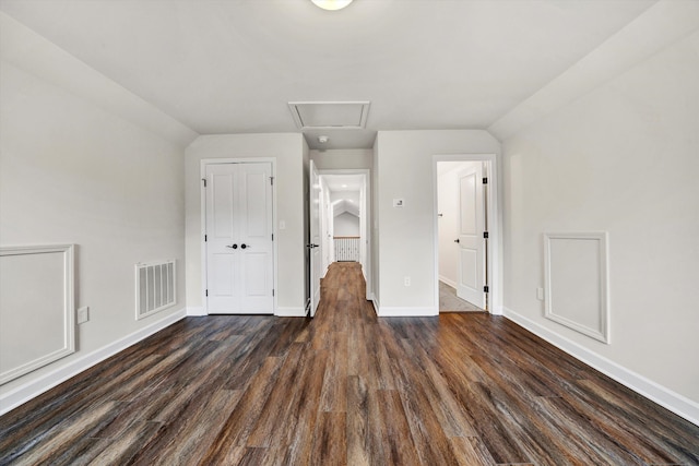 bonus room with dark hardwood / wood-style flooring and vaulted ceiling