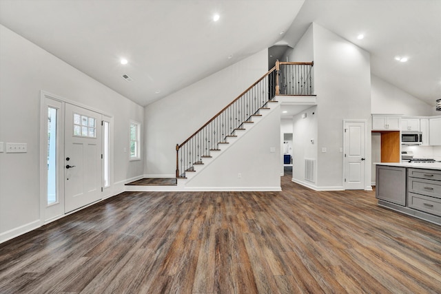 entryway featuring dark hardwood / wood-style floors and high vaulted ceiling