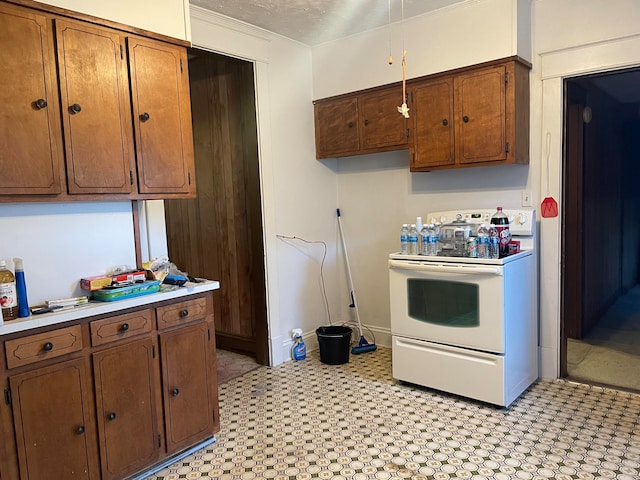 kitchen featuring ornamental molding, a textured ceiling, and electric stove