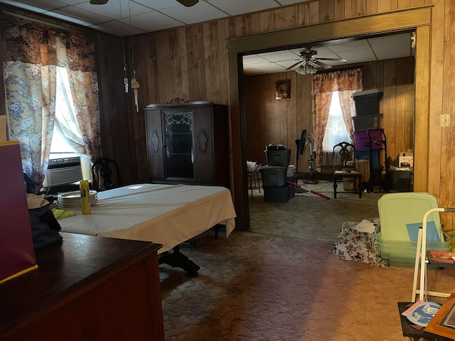 carpeted bedroom featuring cooling unit and wooden walls