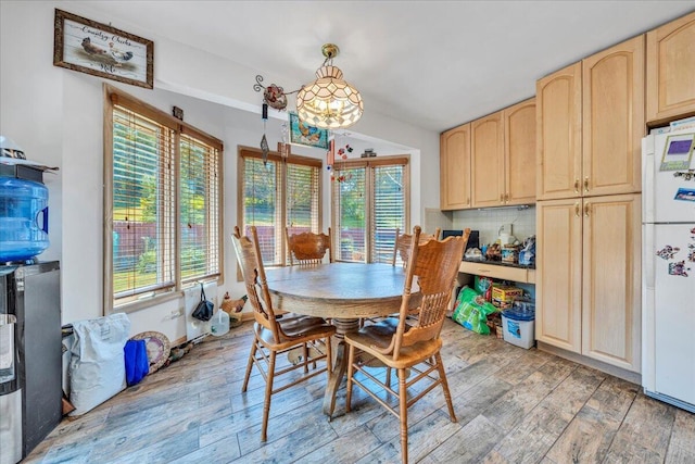 dining space with a chandelier and light wood-type flooring