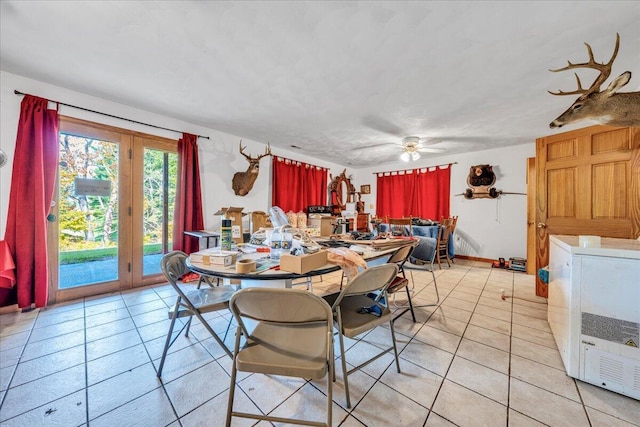 dining area with light tile patterned floors, washer / clothes dryer, and a ceiling fan