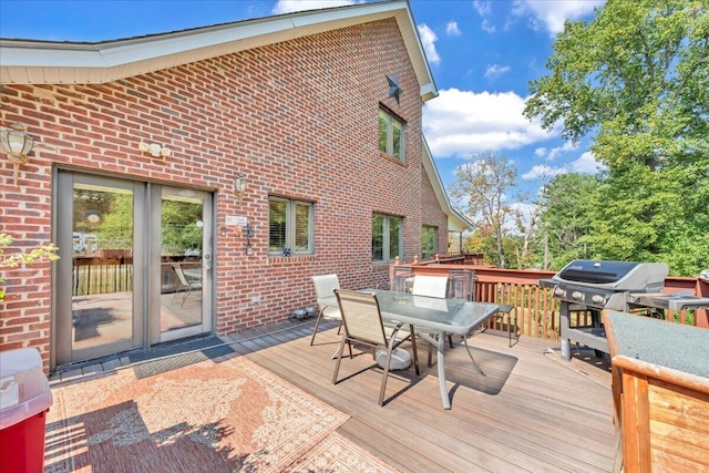 deck featuring area for grilling and outdoor dining area