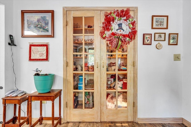 interior details featuring wood finished floors and baseboards