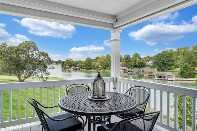 deck with a lawn and a water view