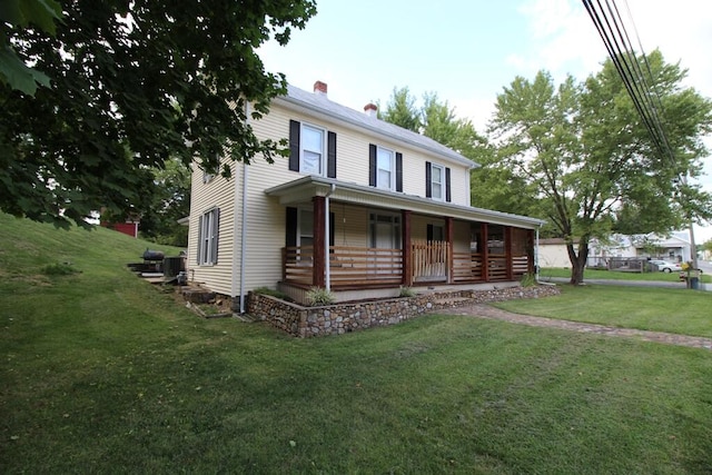 view of front of home with a front yard and a porch